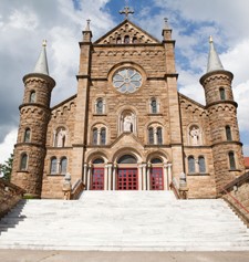 A photo of the facade of the Archabbey Church on a sunny day.