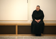 Photo of a monk sitting in the Archabbey Church