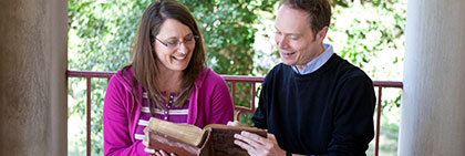 Photo of students reading a book at the Memorial Lobby.