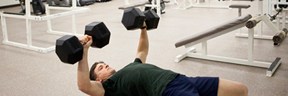 Photo of a man working out in the student gym.